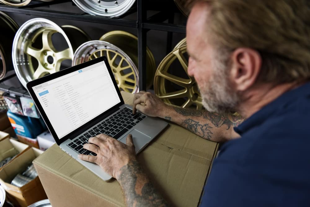 auto-mechanic-tattoos-checking-email-laptop.jpg