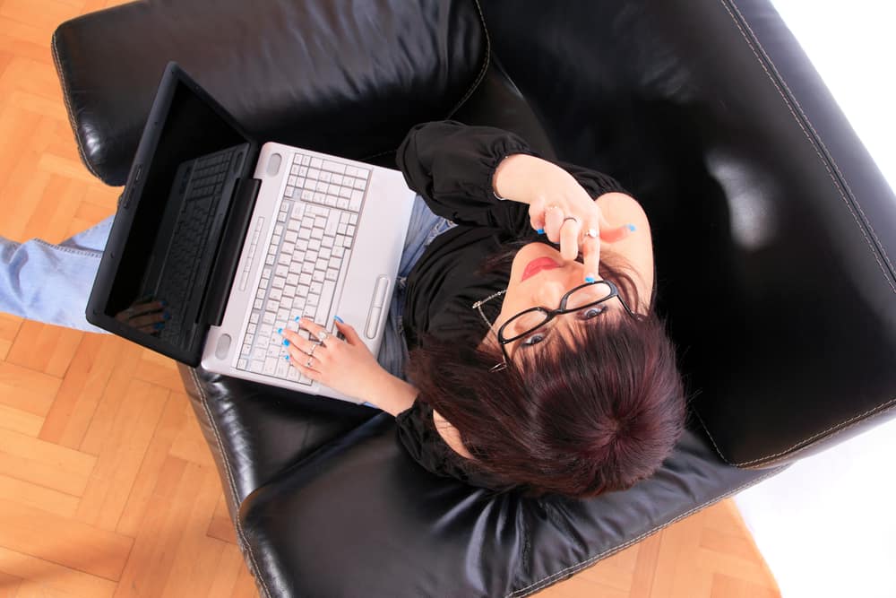 young-woman-looking-up-glasses-laptop.jpg