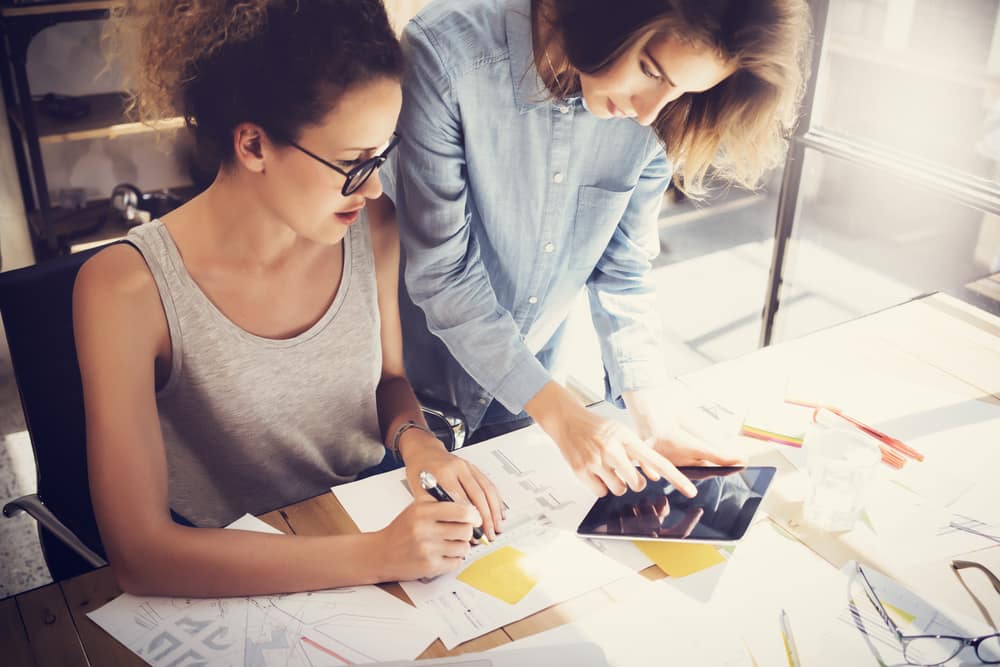 young-women-coworkers-tablet-loft-office.jpg